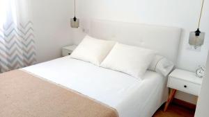 Posteľ alebo postele v izbe v ubytovaní Apartamento Begoña