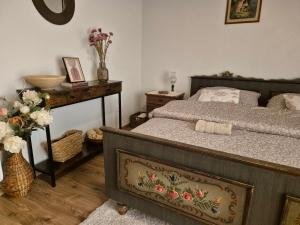a bedroom with a bed and a table with flowers at Apartmány Anička vo Važci in Važec