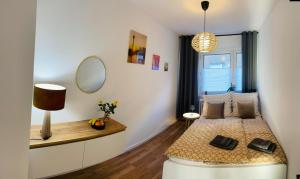 a small bedroom with a bed and a mirror at Sunny Appartement in Düsseldorf