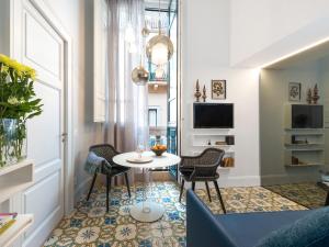 un piccolo soggiorno con tavolo e sedie di Varò Apartment a Taormina