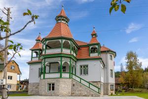 a large building with a tower on top of it at Vila Borka in Borsec