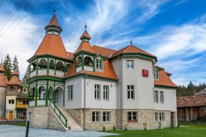 a large white building with an orange roof at Vila Borka in Borsec
