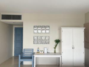 a kitchen with a table and a blue chair at Ben's House in Ao Nang Beach