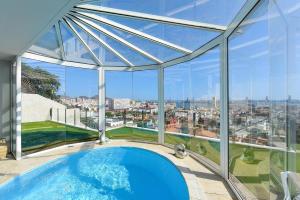 a swimming pool in a glass house with a view at Seaview Holiday Rental by VillaGranCanaria in Las Palmas de Gran Canaria