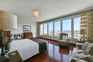 a bedroom with a bed and a large window at Seaview Holiday Rental by VillaGranCanaria in Las Palmas de Gran Canaria