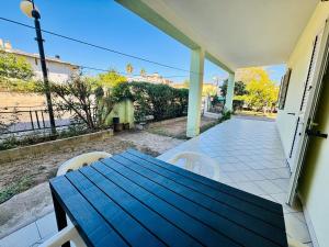 een houten tafel en stoelen op een terras bij Asfodeli 19 in Centro in San Teodoro
