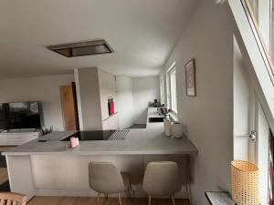 a living room with a table and chairs at Kaalundsvej 13, Fredericia in Fredericia
