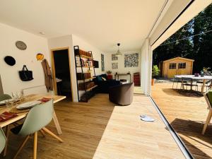a living room with a table and a dining room at Maison à 10 min d'Angers in Mûrs-Érigné