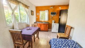 a kitchen with a table and chairs and a refrigerator at PUEBLO MIO in Cosquín