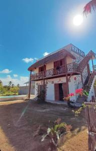 a house with a balcony on the side of it at Villa Yvytu - Praia do Preá in Prea +12 photos