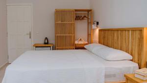 a bedroom with a large white bed in a room at Golden Lighthouse Hotel in Patara