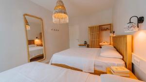 a bedroom with two beds and a mirror at Golden Lighthouse Hotel in Patara