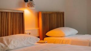 a bedroom with two beds and a headboard at Golden Lighthouse Hotel in Patara