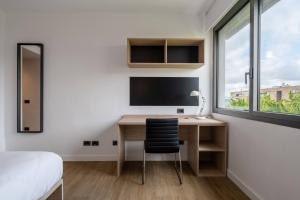 TV a/nebo společenská místnost v ubytování Micampus Pamplona Student Residence
