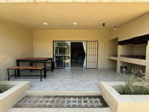 a patio with a wooden table and a bench at Cabañas Cuesta in Cordoba