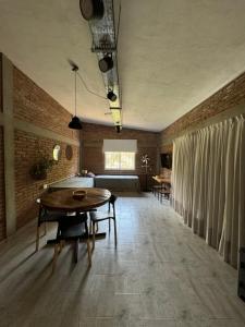 a living room with a table and a bed at Cabañas Cuesta in Cordoba +12 photos