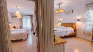 a hotel room with two beds and a bathroom at Golden Lighthouse Hotel in Patara