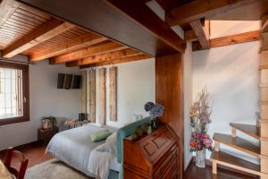 a bedroom with a bed with a wooden dresser at BACARìA BED&BREAKFAST in Bassano del Grappa