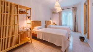a bedroom with two beds and a large window at Golden Lighthouse Hotel in Patara