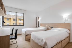 Postel nebo postele na pokoji v ubytování Micampus Pamplona Student Residence