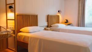 a hotel room with two beds and a window at Golden Lighthouse Hotel in Patara