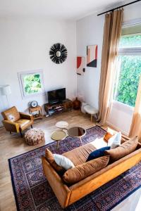 a living room with a large couch in a room at Elegant 2 bedroom triplex with parking Honfleur in Honfleur +12 photos