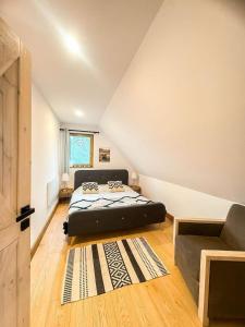 a bedroom with a bed and a couch at Country house in Dziemiany +34 photos