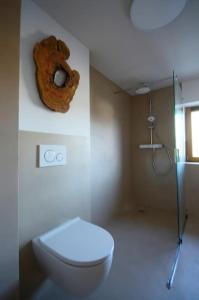 a bathroom with a toilet and a donut on the wall at Ferienhaus Sterntaler mit Sauna in Schwalmstadt +23 photos