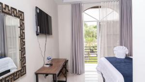 Postel nebo postele na pokoji v ubytování Hotel Boutique Nueva Valladolid