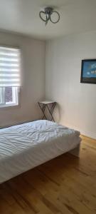 a bedroom with a bed and a ceiling fan at Chambres à louer in Montréal