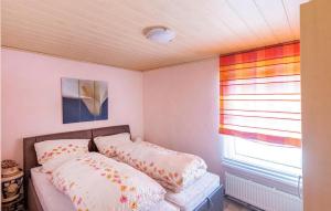 a bedroom with a bed with two pillows on it at Ferienwohnung Mirow in Mirow