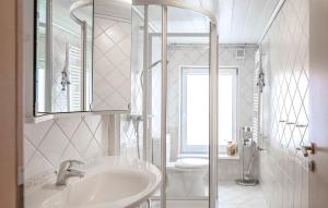 a white bathroom with a sink and a toilet at Ferienwohnung Mirow in Mirow