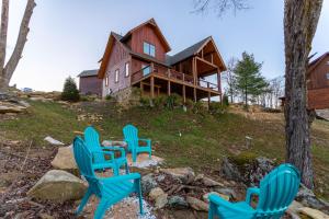 a group of blue chairs in front of a house at The Grape Escape at Eagles Nest in Elk Park
