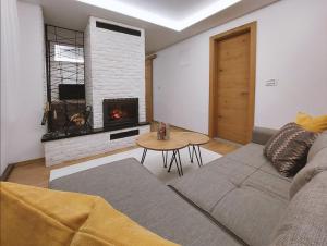 a living room with a couch and a fireplace at ATTIC in Jahorina