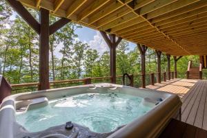 a hot tub on the deck of a cabin at Clouds Rest at Eagles Nest in Beech Mountain