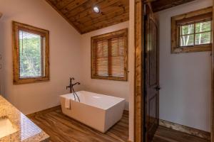 a bathroom with a tub and a window at Clouds Rest at Eagles Nest in Beech Mountain