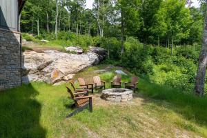a group of chairs sitting around a fire pit at Clouds Rest at Eagles Nest in Beech Mountain