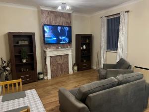 a living room with two couches and a television at Kings view in Doncaster