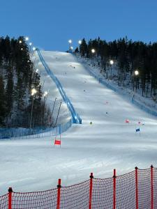 a group of people skiing down a snow covered slope at Levi Star 1003 in Levi