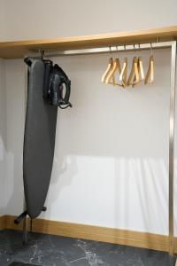 a room with a shelf with shoes hanging on a wall at 42 Studio 8 in Komotini