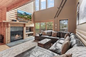 a living room with a couch and a fireplace at Deer Valley Luxury 3 BR, Private Master Suite, Private Hot Tub, Amazing Views in Park City