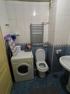 a small bathroom with a toilet and a sink at Apartman Raj in Kraljevo