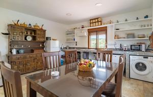 a kitchen with a table with a basket of fruit on it at Pet Friendly Home In Algarinejo in Algarinejo
