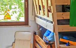 a room with a bunk bed and a desk at Ferienhaus Reetzowusedom in Reetzow