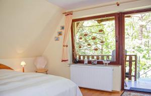 Un dormitorio con una cama y una ventana grande. en Ferienwohnung Dierhagen, en Neuhaus