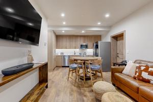 a living room with a couch and a table at Lion Square Lodge South 255, 257 & 261 in Vail