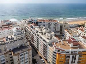 an aerial view of a city and the ocean at Caravelas 2-Bedroom Apartment with Pool - 50m from the Beach in Armação de Pêra