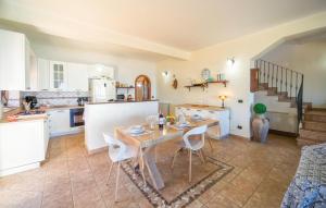 a kitchen and dining room with a table and chairs at 4 Bedroom Awesome Home In Caronia in Caronia
