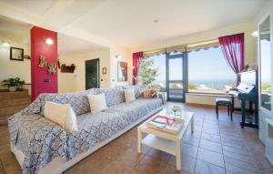 a living room with a couch and a table at 4 Bedroom Awesome Home In Caronia in Caronia