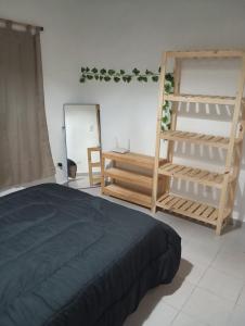 a bedroom with a bed and a mirror and shelves at Buenas Ondas in Mar Azul